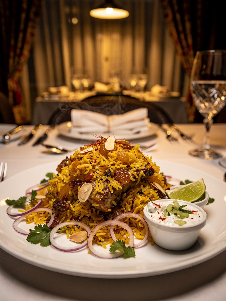 Delicious Chicken Biryani with Raita and Garnishes