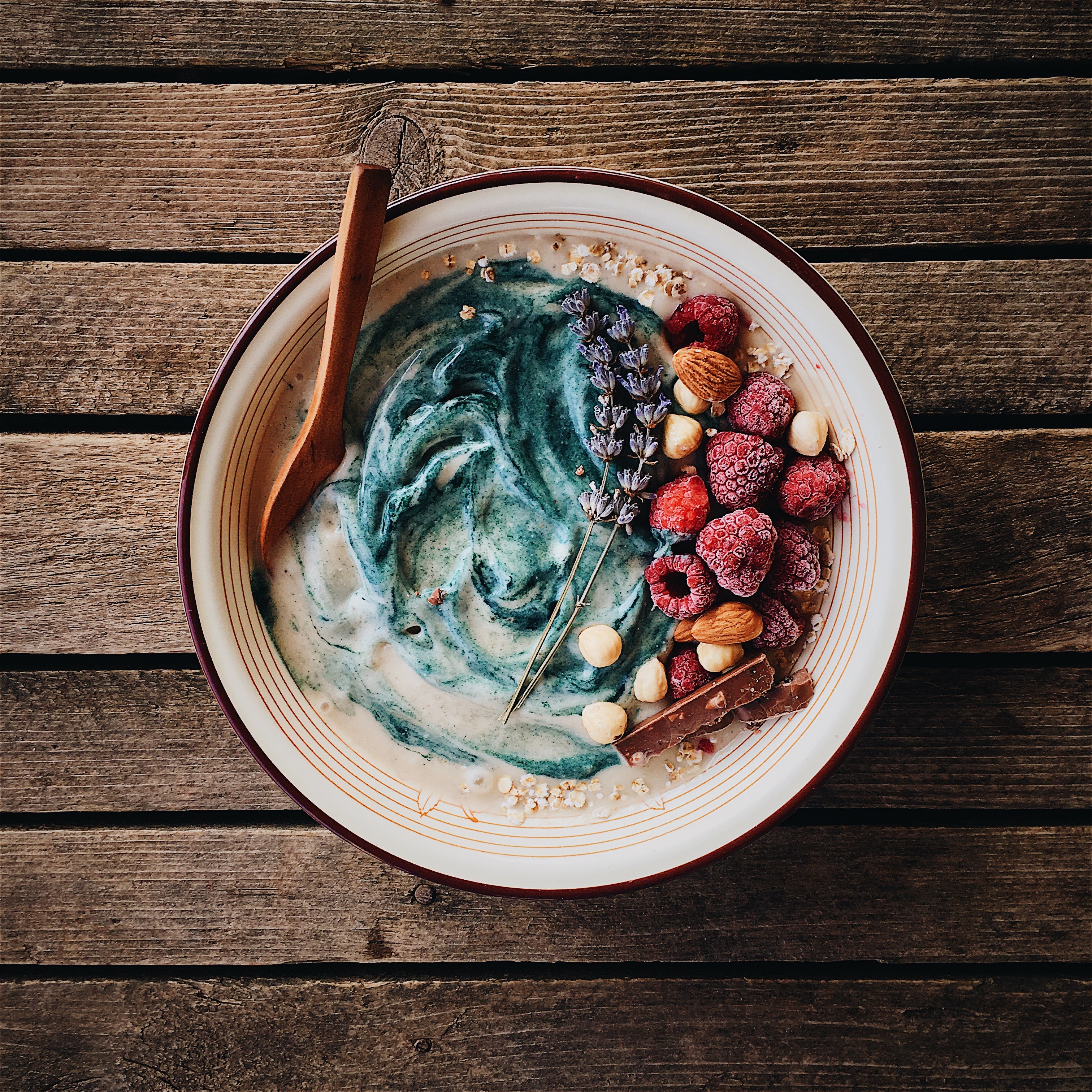 Cereals bowl with frozen raspberries and nuts