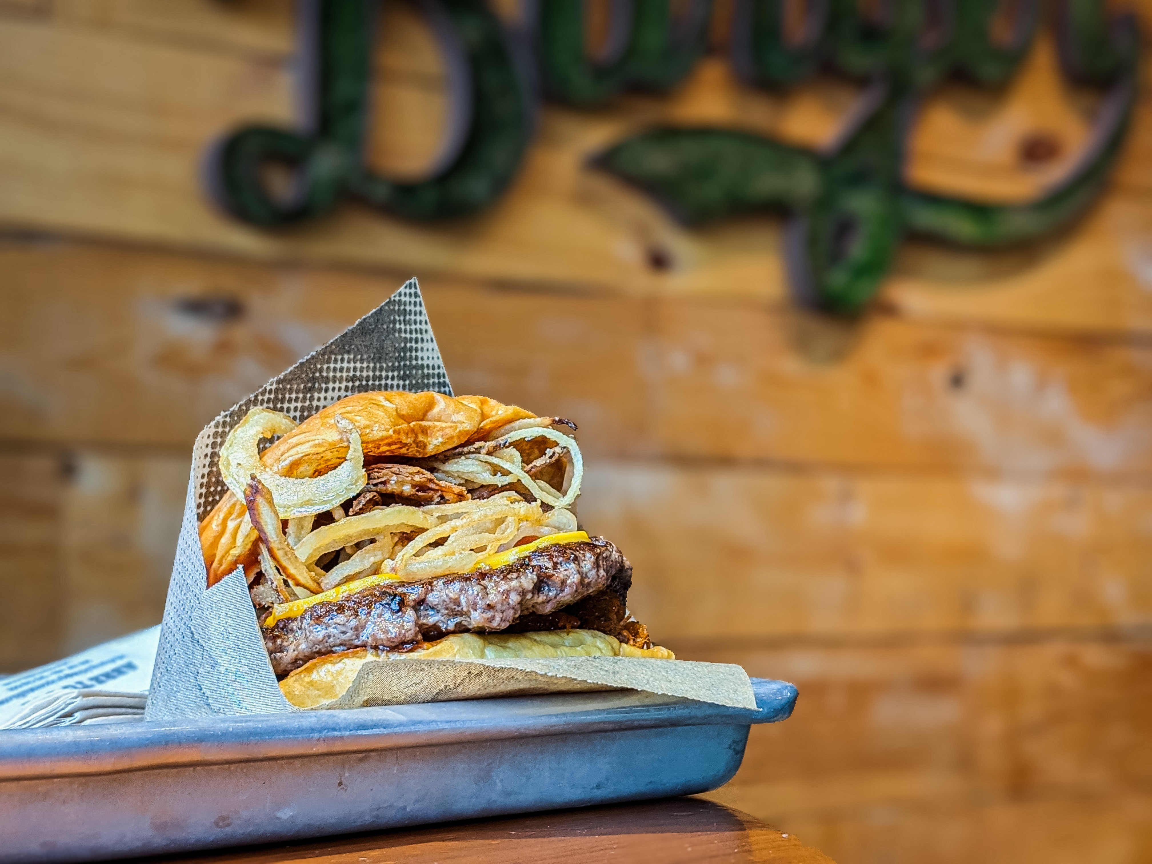 Cheese burger with fried onion on a tray