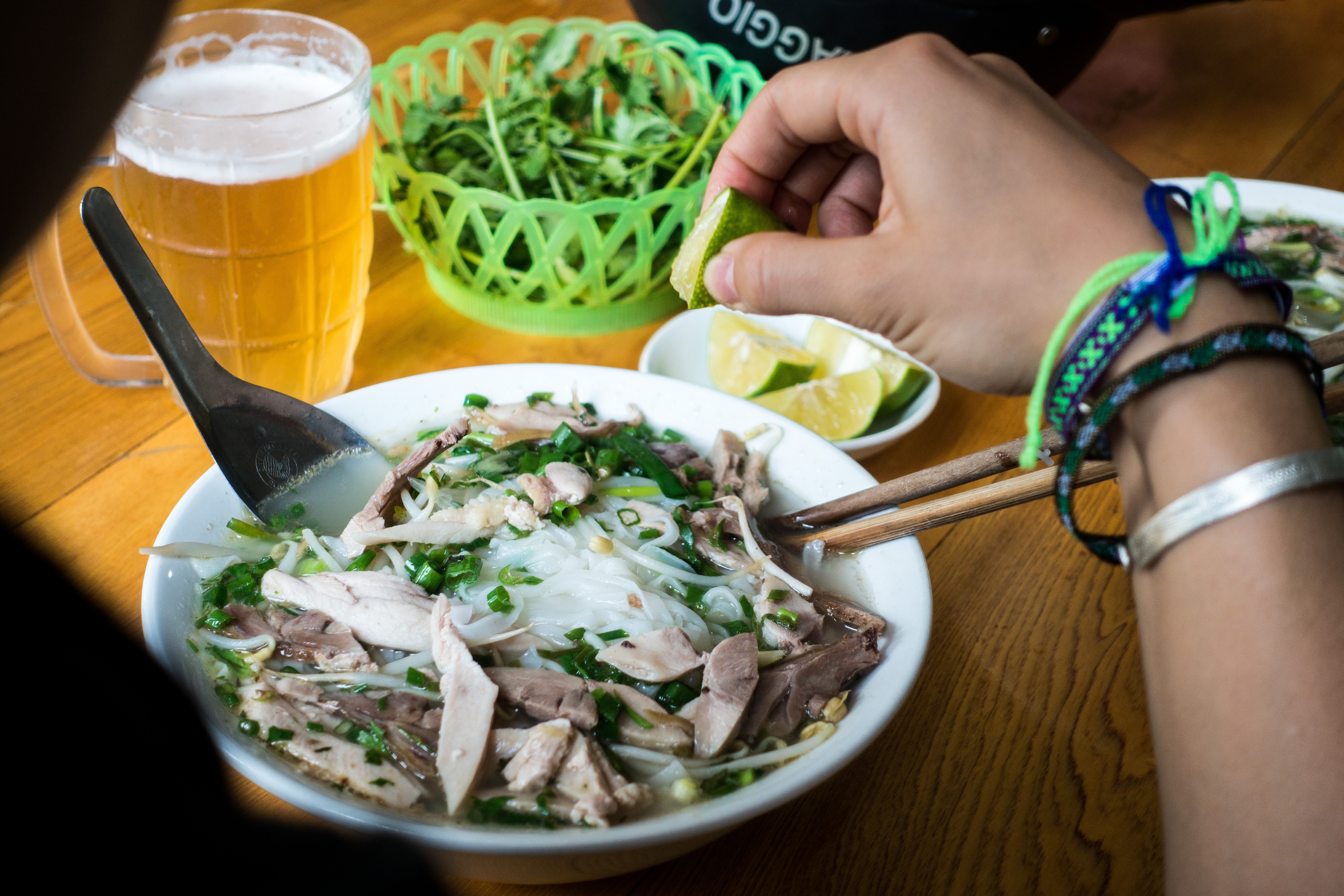 Eating Vietnamese Pho soup with fresh lime