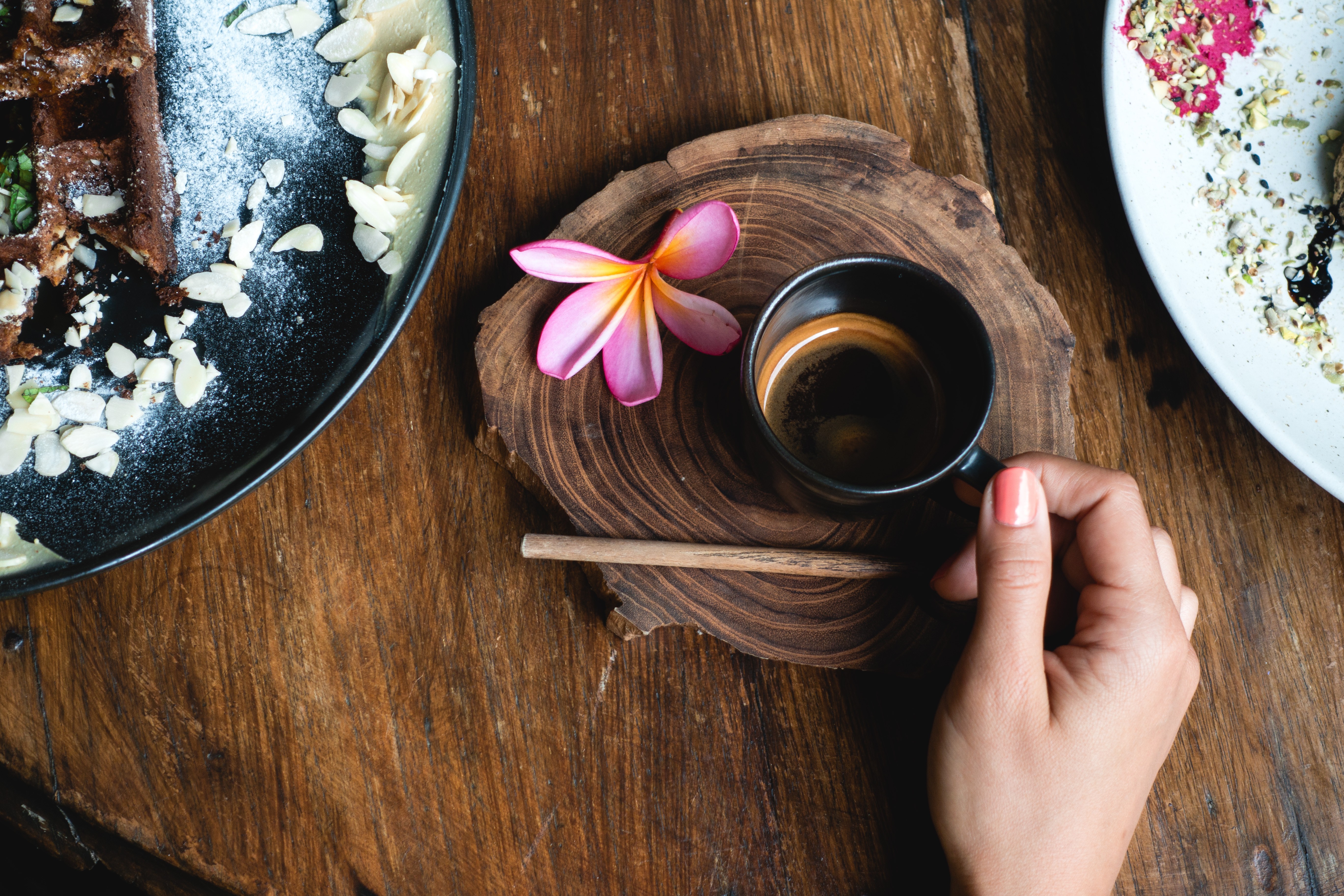 Girl holding a black cup with espresso coffee