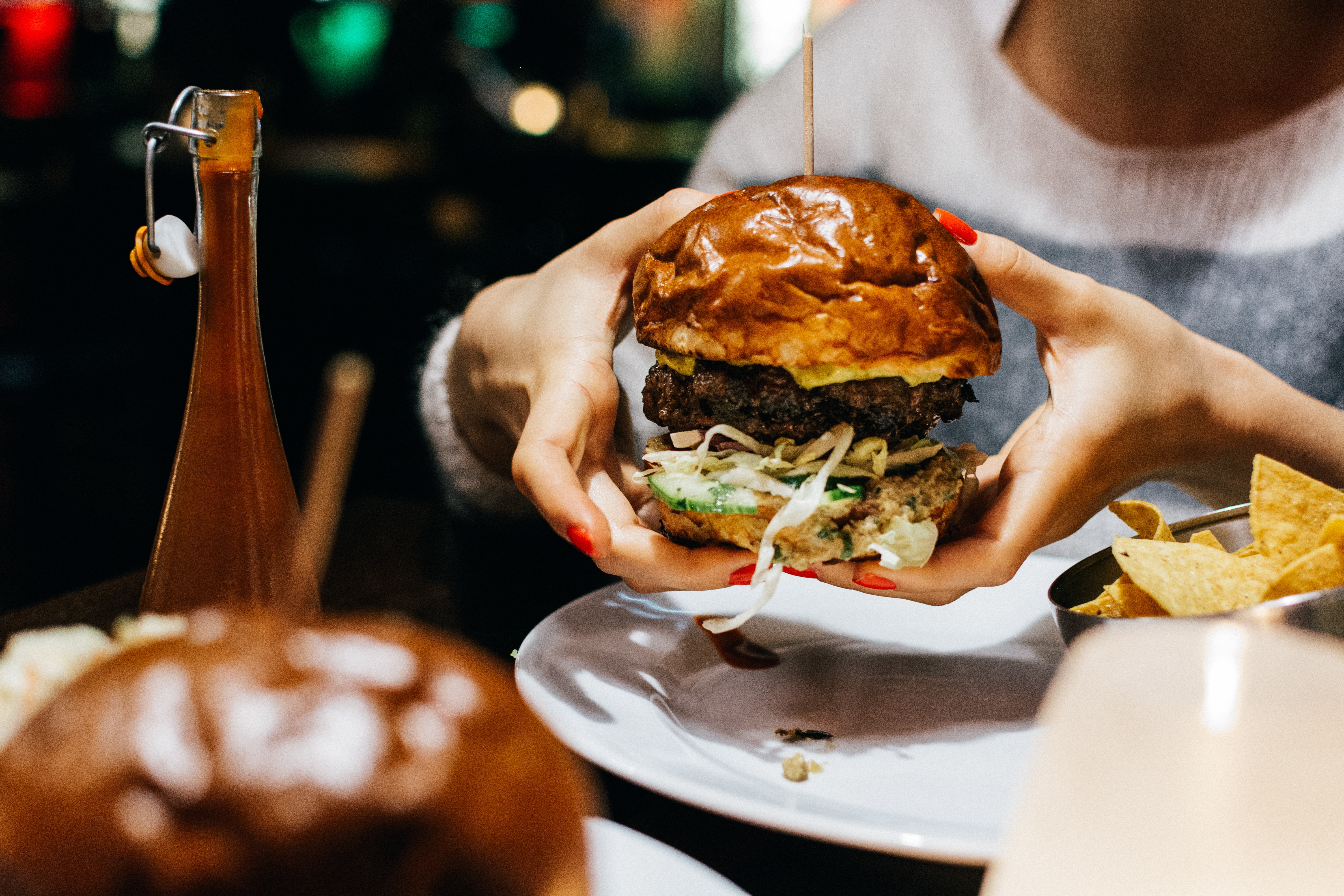 Girl holding a juicy beef burger