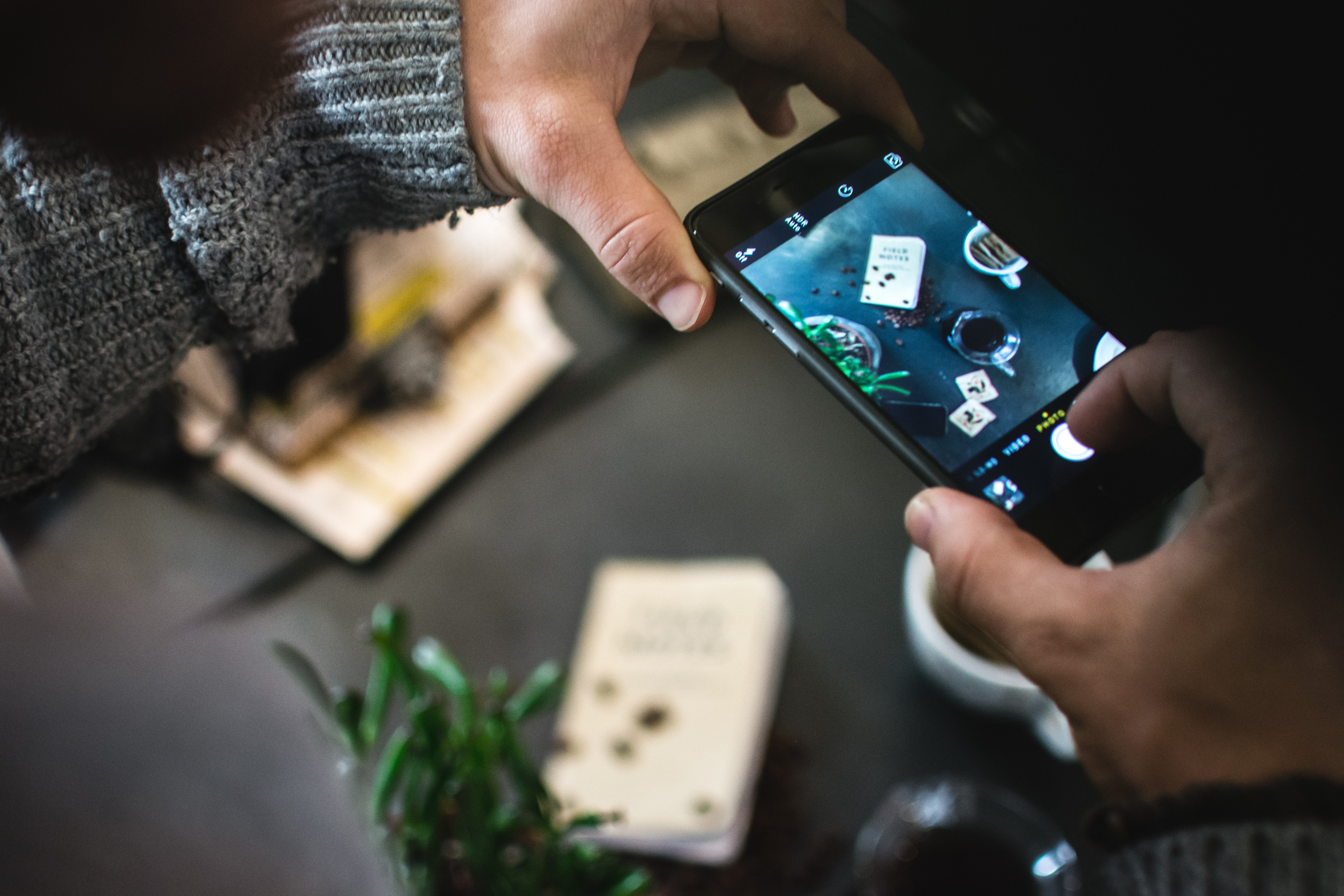 Man shooting coffee with his iPhone