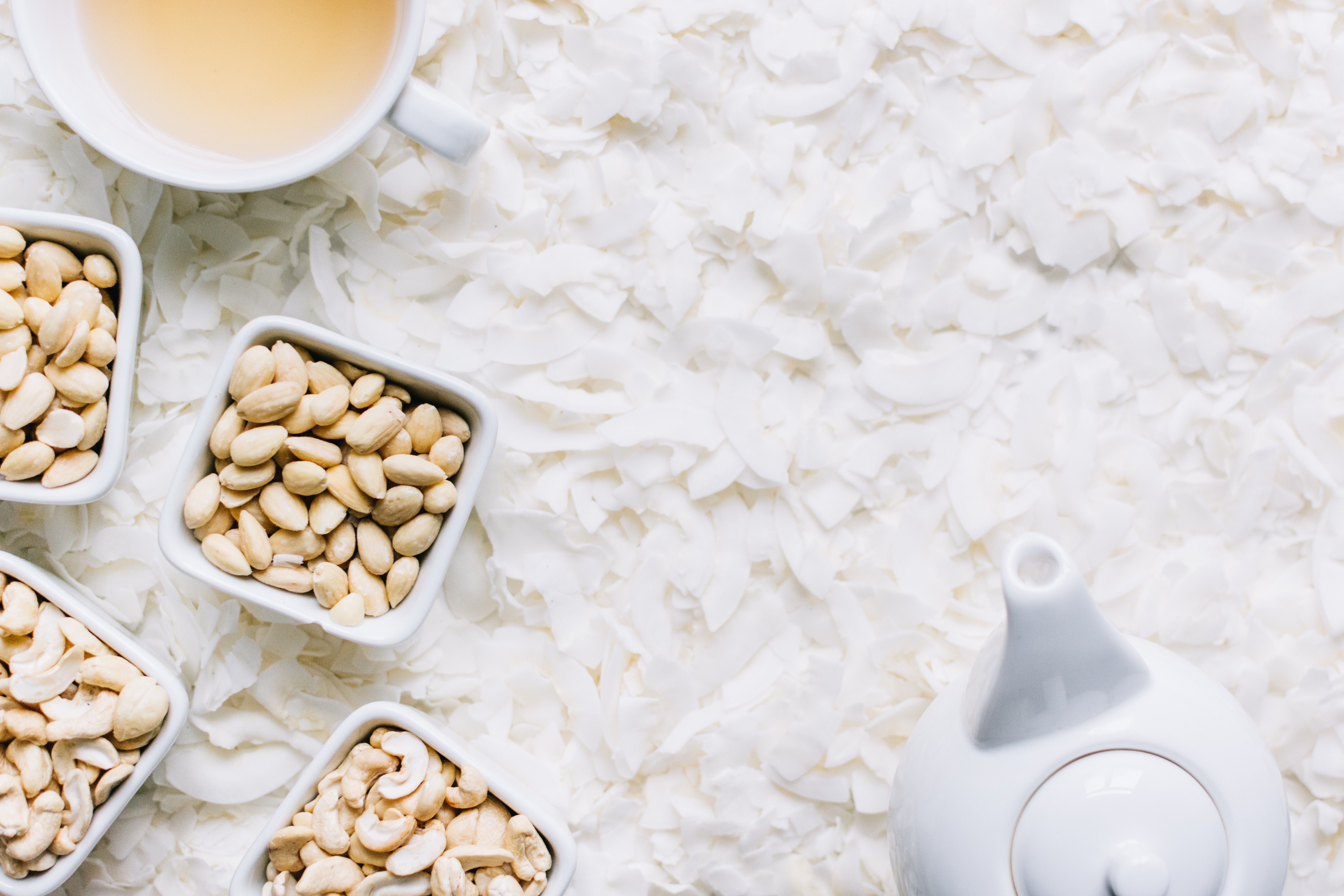 Nuts with tea on coconut flakes