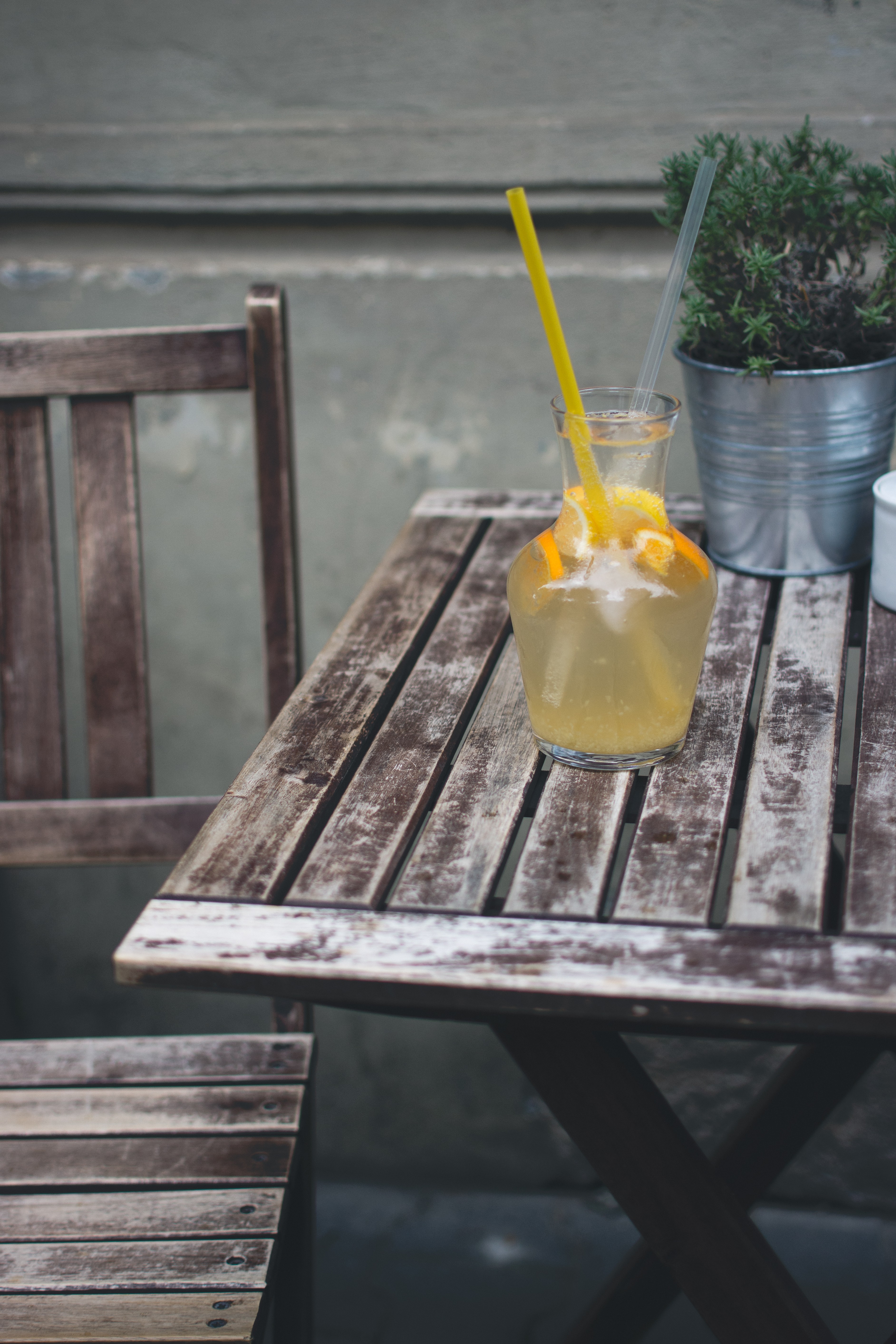 Orange lemonade at a wooden desk outside