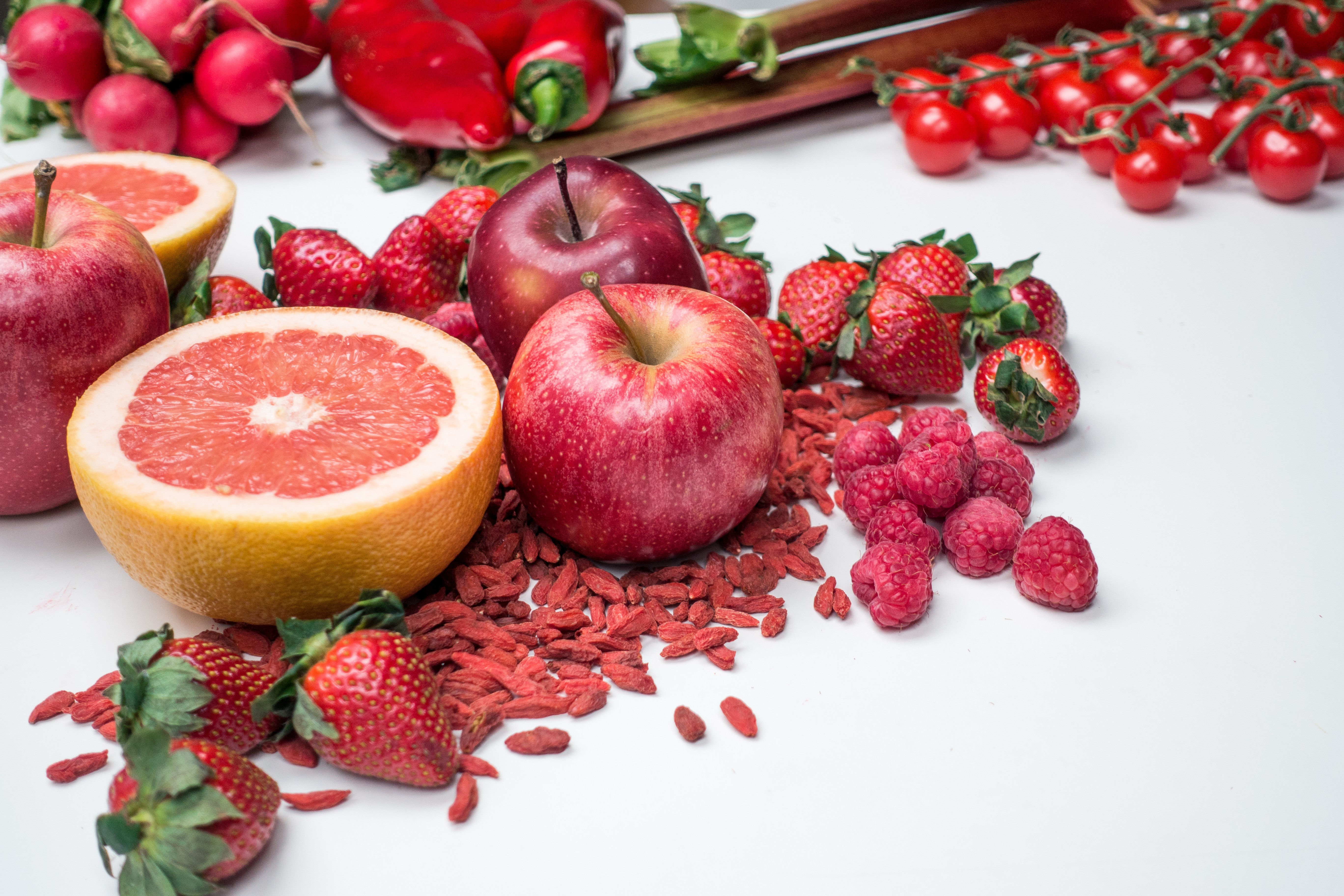 Red apples, grapefruit, raspberries and other fruits